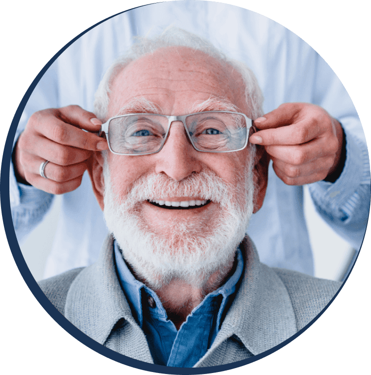 A man putting his head to the ear of an older gentleman.